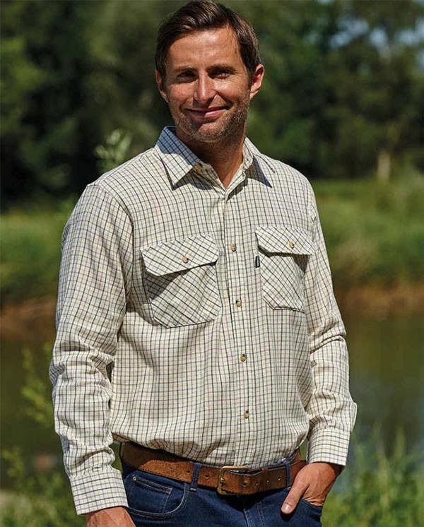 Man in countryside wearing Champion Tattersall shirt in green check, classic country look for farm work, field sports or everyday wear