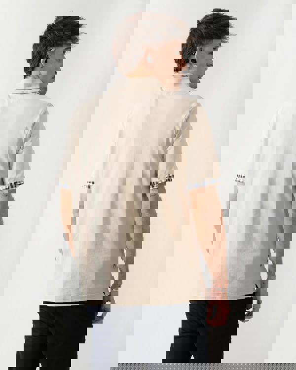 back shot of a model wearing an Aquascutum Mens Club Check Stretch Piquet Sleeves Polo Shirt in Beige 03