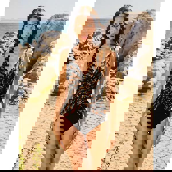 Black and gold Miraclesuit Raya safari charmer swimsuit with deep V-neck