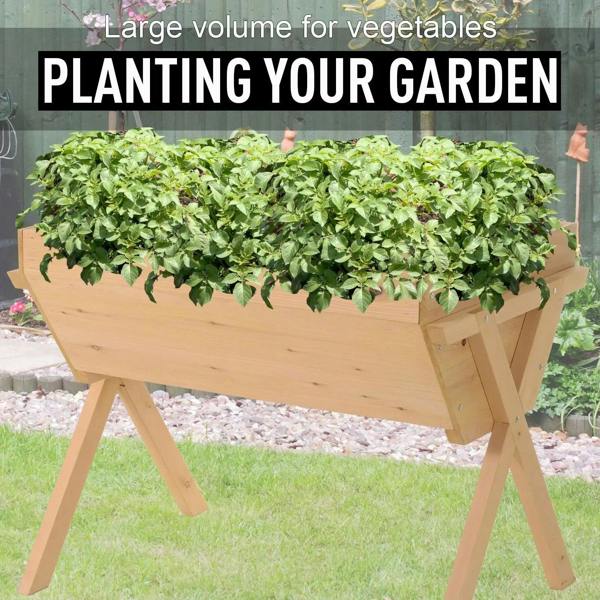 Raised wooden vegetable planter bed filled with dense leafy greens in the tray.
