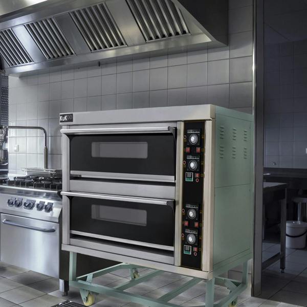 KuKoo large commercial pizza oven with two black baking chambers, stainless steel exterior, and control panel in a professional kitchen setting