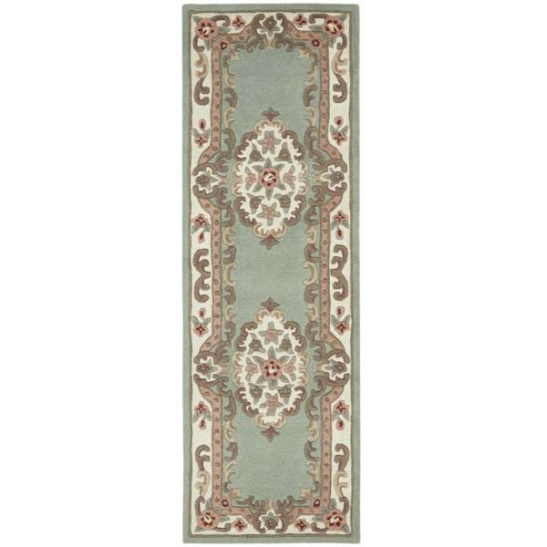 Decorative rug with intricate patterns on a light green background