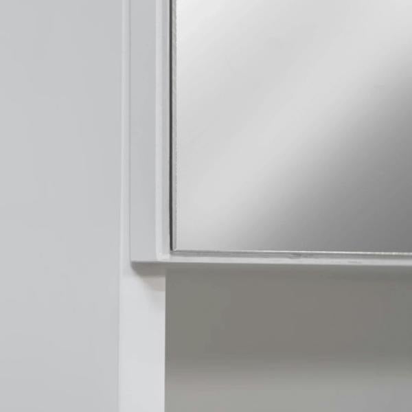 White bathroom mirror cabinet corner with framed mirrored door edge detail