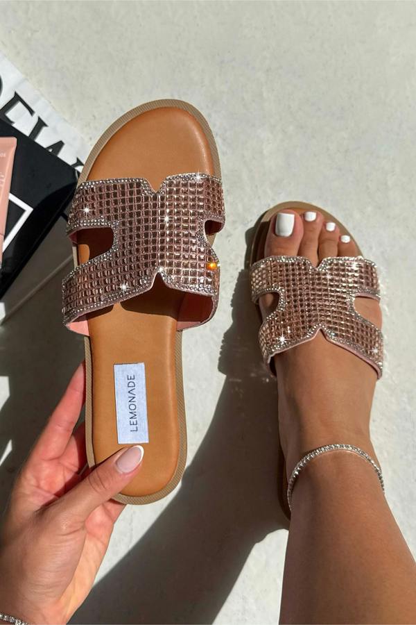Pair of embellished sandals with a visible brand label on a neutral background