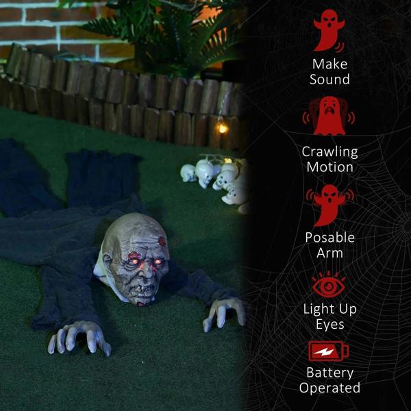 Crawling zombie Halloween decoration on grass with glowing red eyes and posed arms