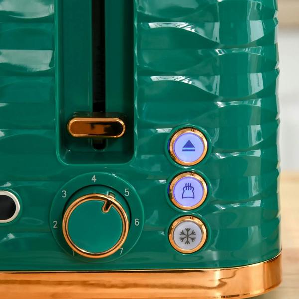 Green toaster control panel with browning dial and indicator buttons in gold trim.