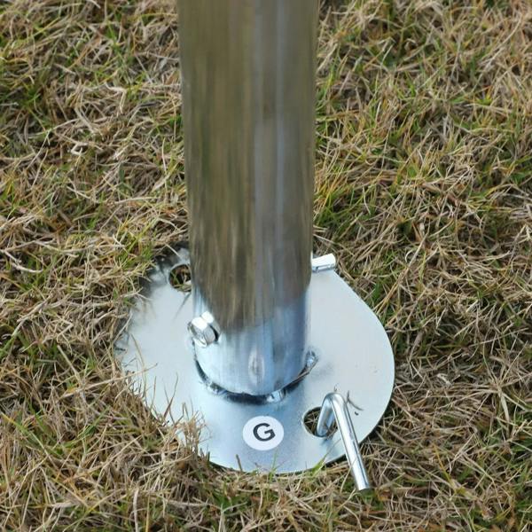 Galvanized steel carport canopy base plate with ground peg on grass for anchoring