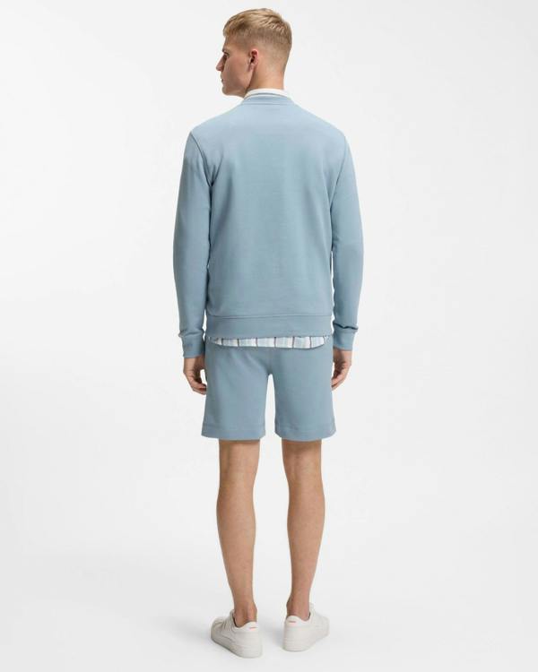 Model wearing BOSS Orange Westart Mens Crew Neck Sweatshirt With Logo Patch in Light/Pastel Blue 458 - Back