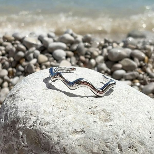 Wavy bracelet on a beach rock.