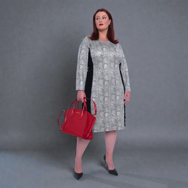 Women's Plus Size Black White Animal Print Bodycon Midi Vegan Leather Dress shown from the front, styled with black heels for a chic look.Plain Background.