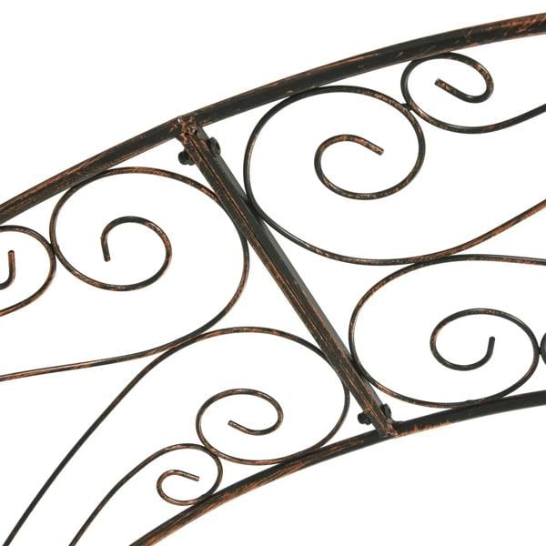 Black metal trellis close-up with decorative vine scroll ironwork on tubing