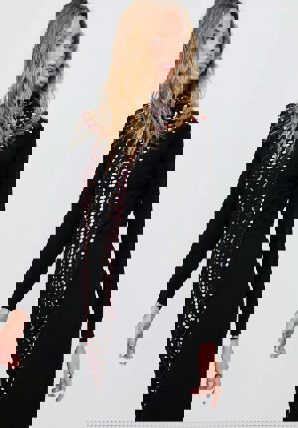 Woman wearing a black dress with a patterned scarf on a white background