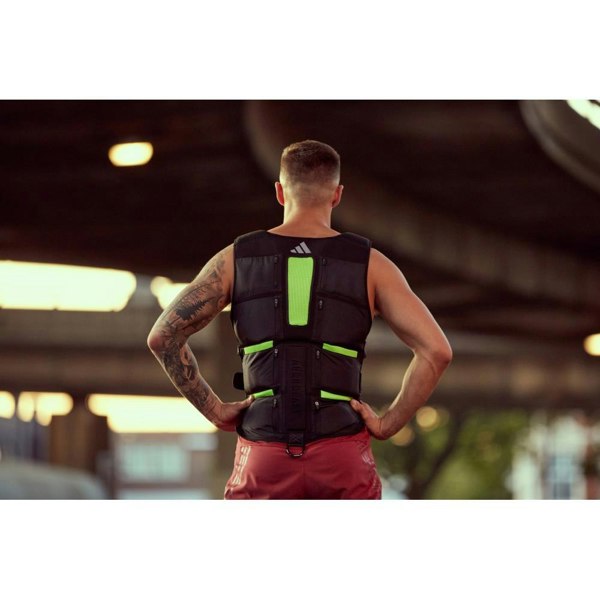 Person wearing an Adidas weight vest in an indoor setting