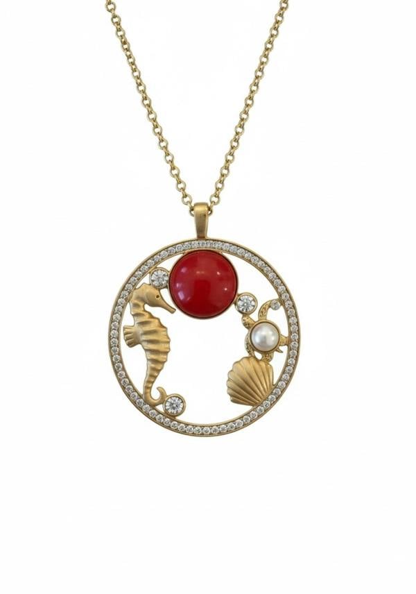 18k gold plated oceanic pendant necklace with a coral red stone and cubic zirconia.