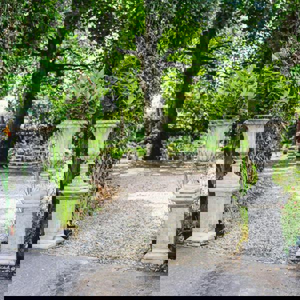 Pair of Large Stone Cast Flute Urns and Classic Plinths