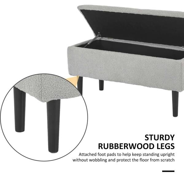 Grey storage ottoman bench with open lid and dark rubber-tipped wooden legs