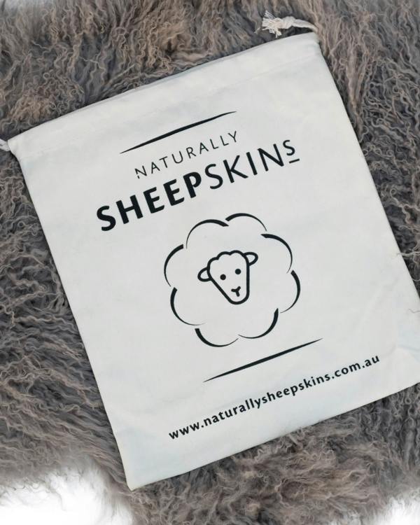 Canvas bag on Grey Mongolian Sheepskin Rug