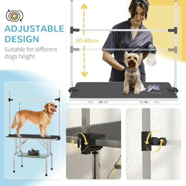 Adjustable pet grooming table with black rubber top and hanging loops; dog being groomed