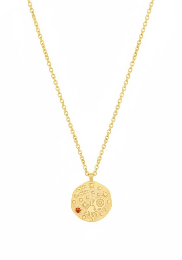 Gold necklace with a round pendant featuring a red gemstone on a white background