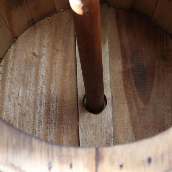 Underside view of barrel table showing umbrella pole and wood support planks
