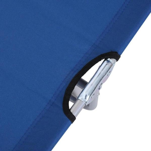 Close-up of blue fabric sun lounger edge with black strap and metal frame