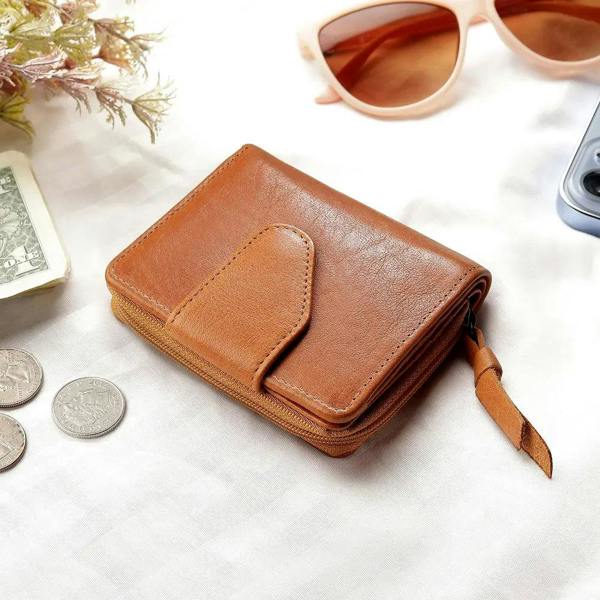 Lifestyle view of cognac  small leather bifold purse