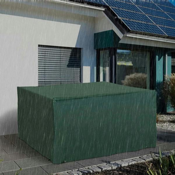Green patio furniture cover over rectangular set outdoors, with elastic hem and securing points.