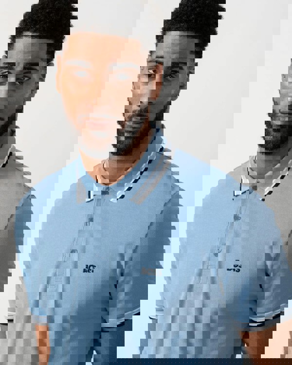 Model wearing BOSS Green Mens Paddy Cotton-Piqué Polo Shirt with Contrast Logo in Open Blue 469 - detail