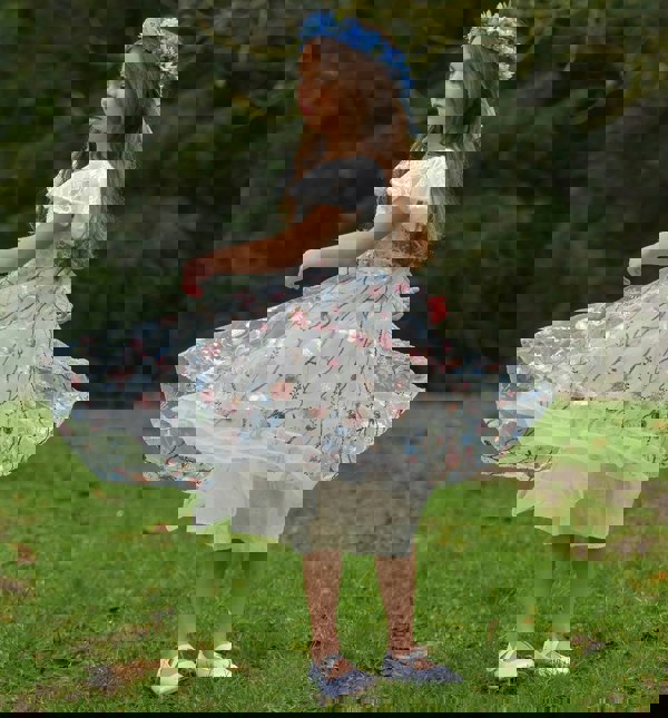 Young girl swirling in dress