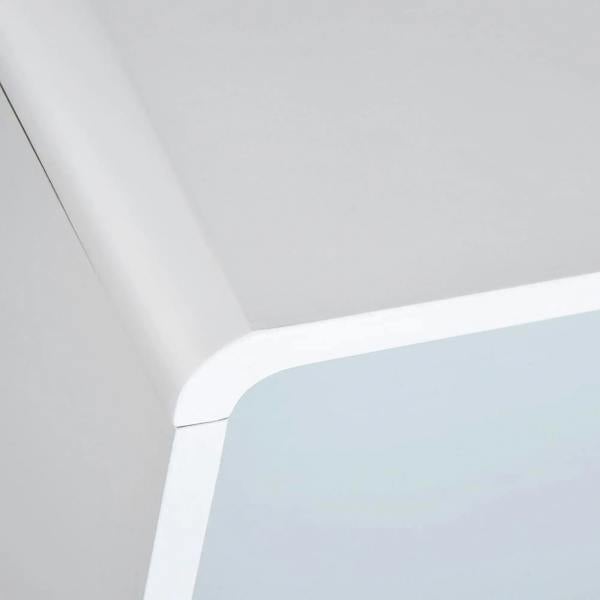 Close-up of rounded white corner edge on bedside cabinet