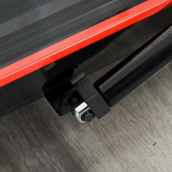 Close-up of foldable walking treadmill base locking hardware near red track stripe