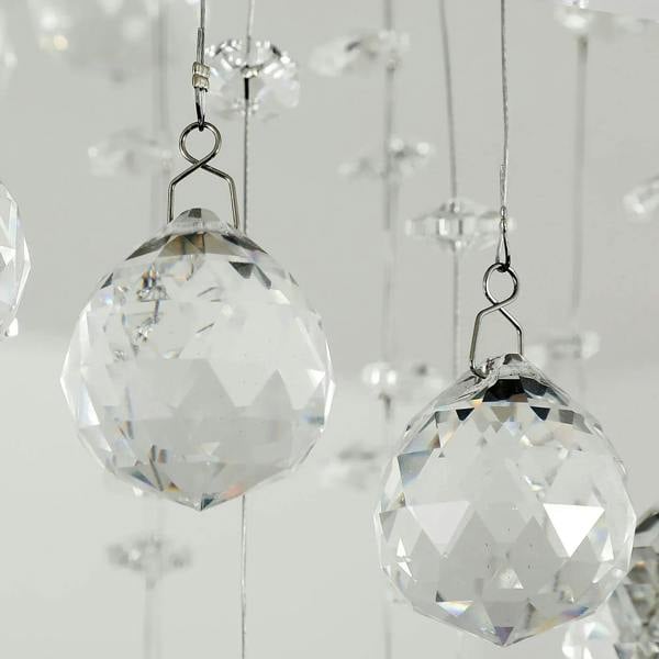 Faceted clear crystal glass ball pendants hanging from thin metal loops