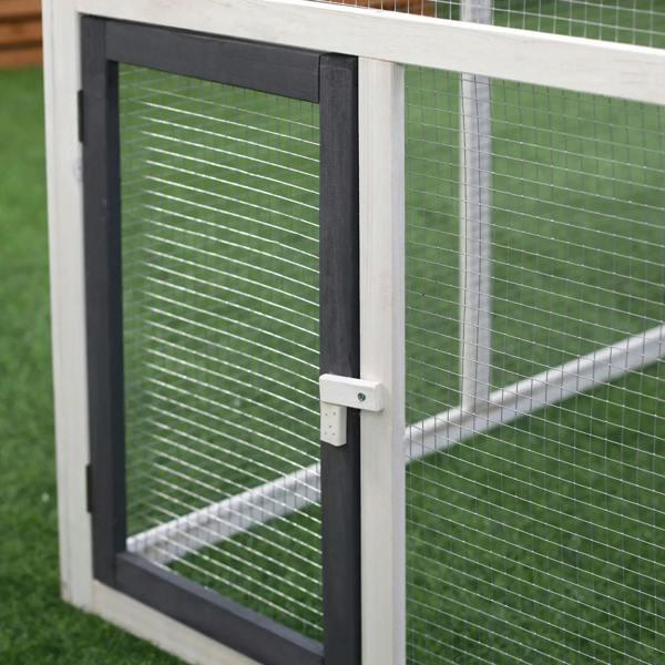 Chicken coop run door with dark frame, wire mesh, and latch handle