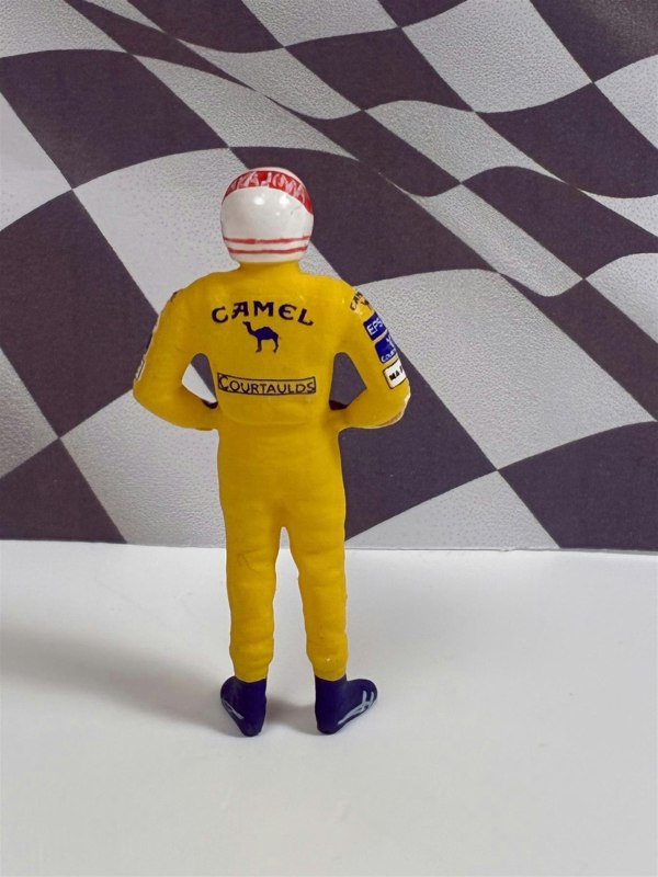 a toy figure of a race car driver