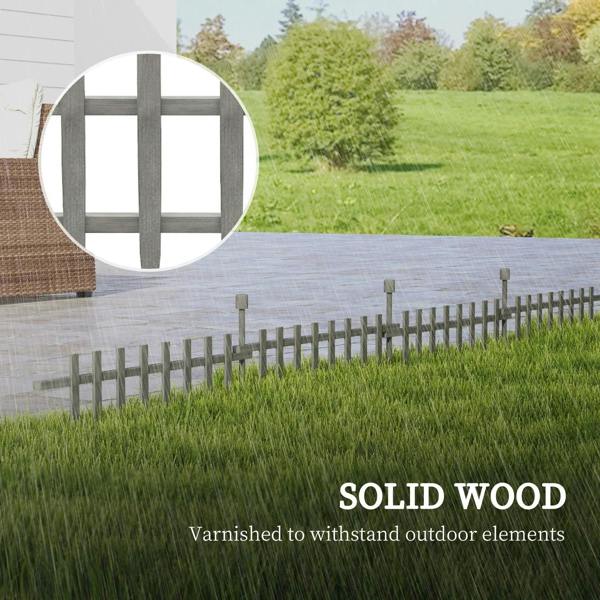 Grey wooden landscape border fence with varnished slats and support posts