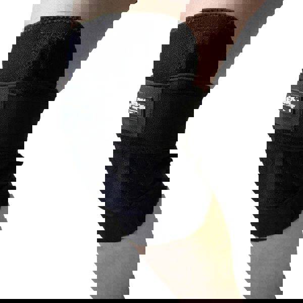 Black knee brace on a person's knee