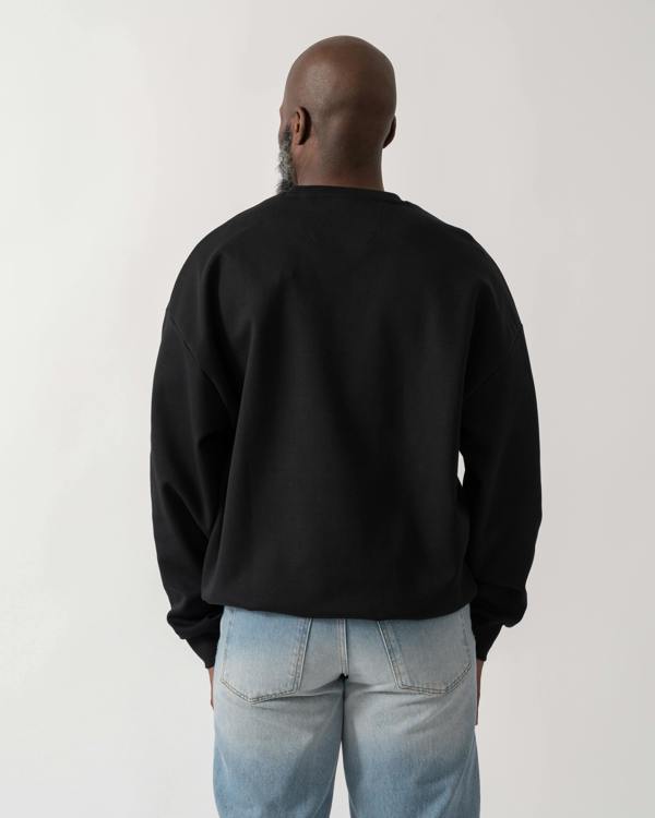 back shot of a Model wearing a BOSS Green Stenson Mens Crew Neck Sweatshirt in Black