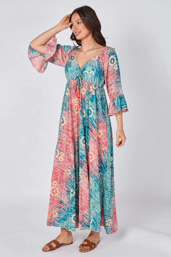Woman wearing a colorful patterned dress on a white background