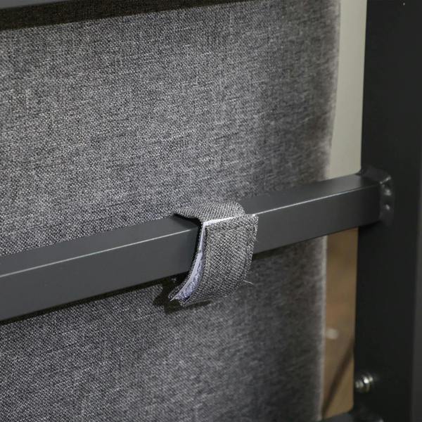 Grey armchair cushion tucked around dark grey armrest and frame