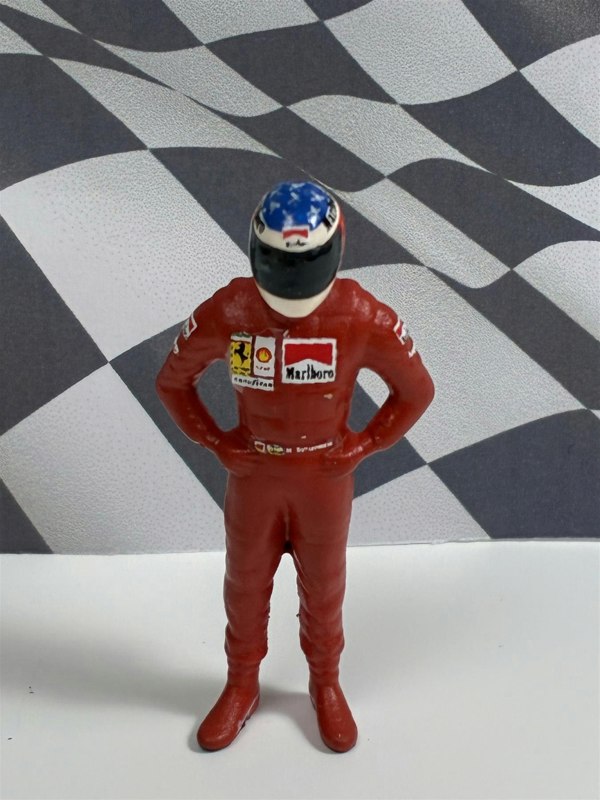 a toy figure of a race car driver