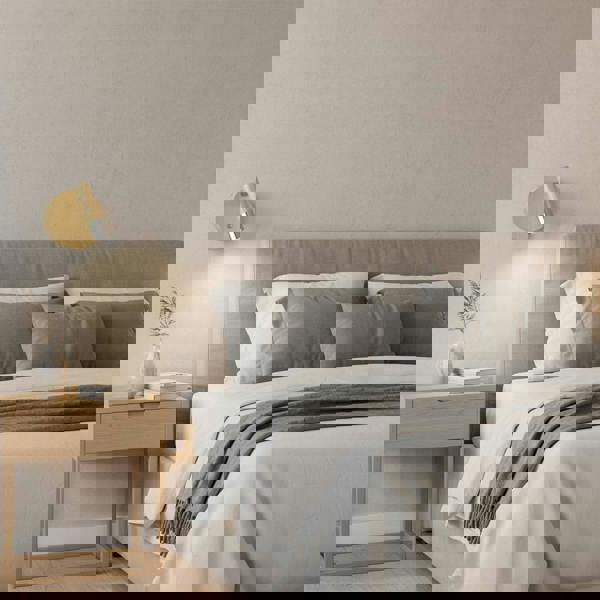 chrome adjustable wooden reading light mounted on the wall next to a bed in a modern bedroom