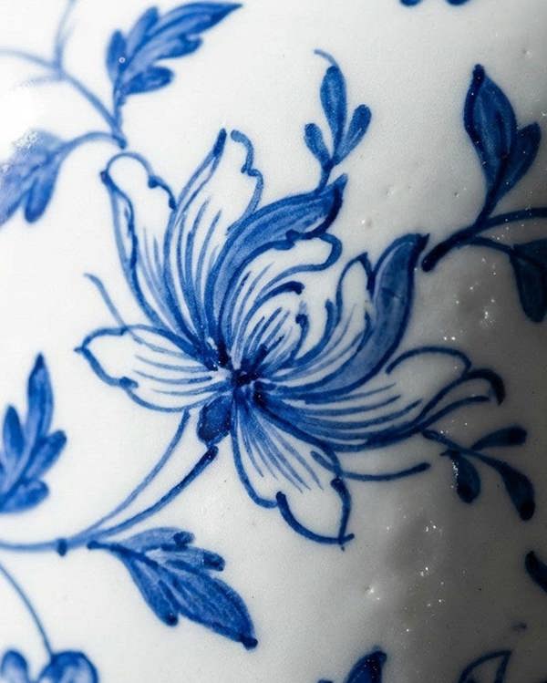 Close-up of blue floral design on white ceramic surface