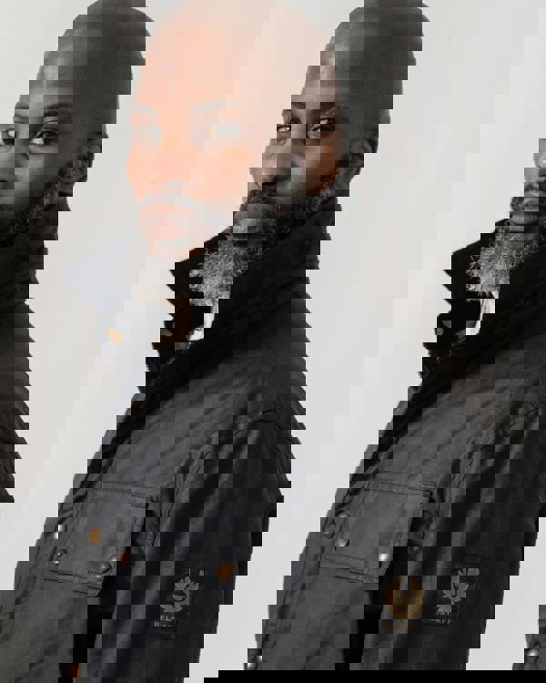 Model wearing Belstaff Ground Mens Jacket in Dark Navy - logo patch