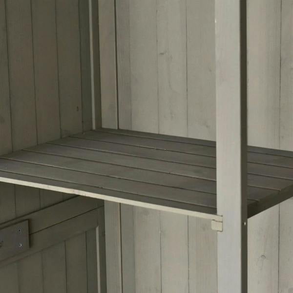 Grey shed interior with mid-height shelf and vertical board walls