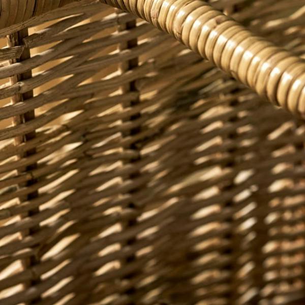 Close-up detail of the tight, multi-toned rattan weave on the side panel of a tall log basket.