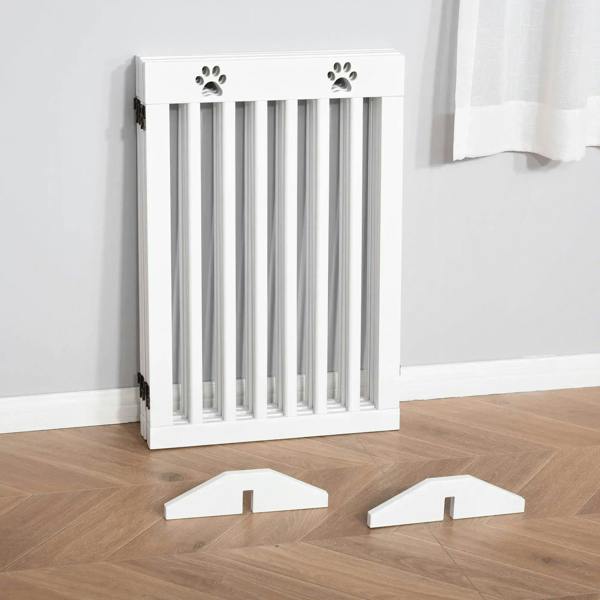 White foldable wooden pet gate with paw-shaped cutouts and vertical slat barrier