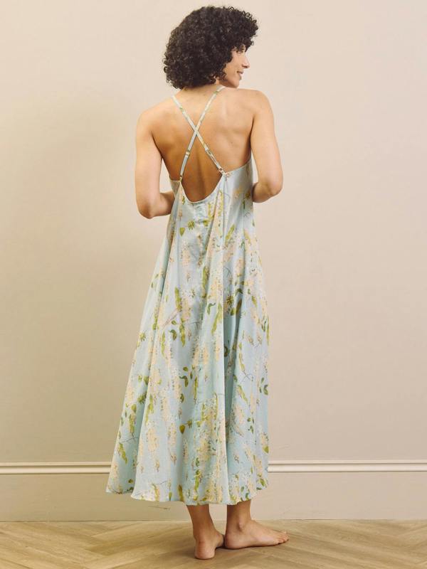 Woman wearing a floral night dress with a neutral background