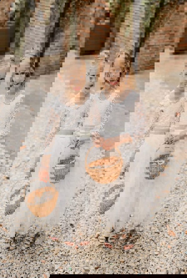 Two little flower girls holding baskets