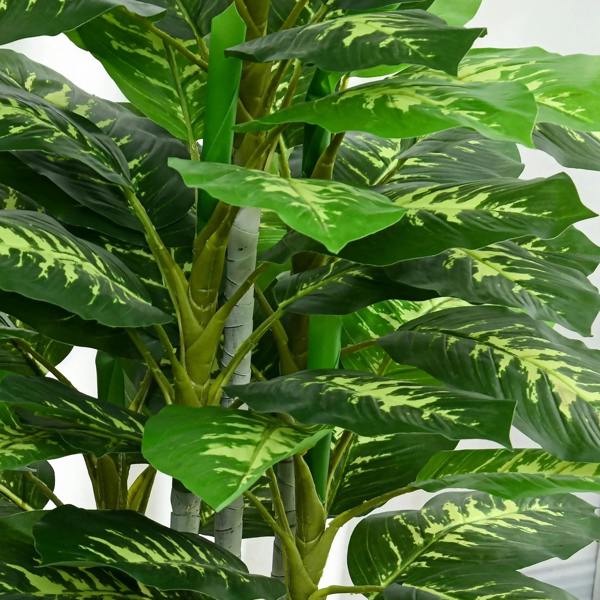 Artificial evergreen tree close-up of variegated green leaves on white-striped stems