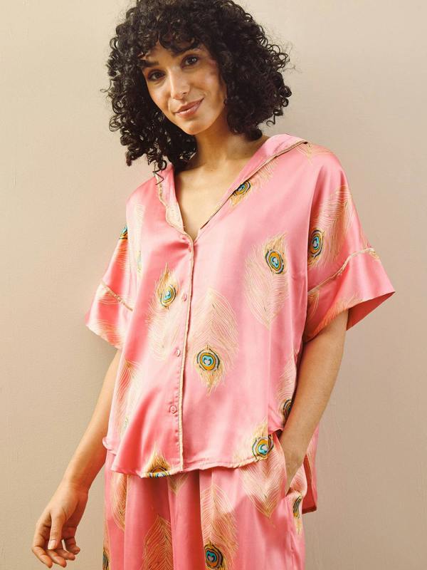 model wears pink long oversized pyjama set with peacock feather design